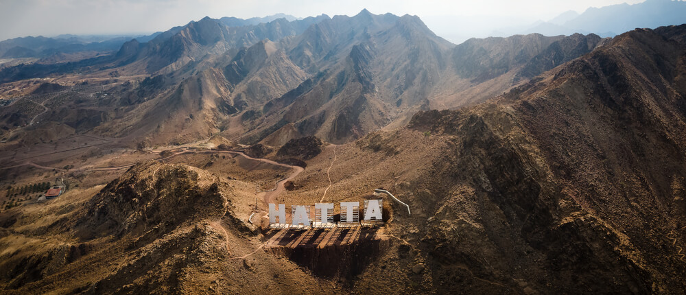 Iconic giant Hatta sign on mountain ridge